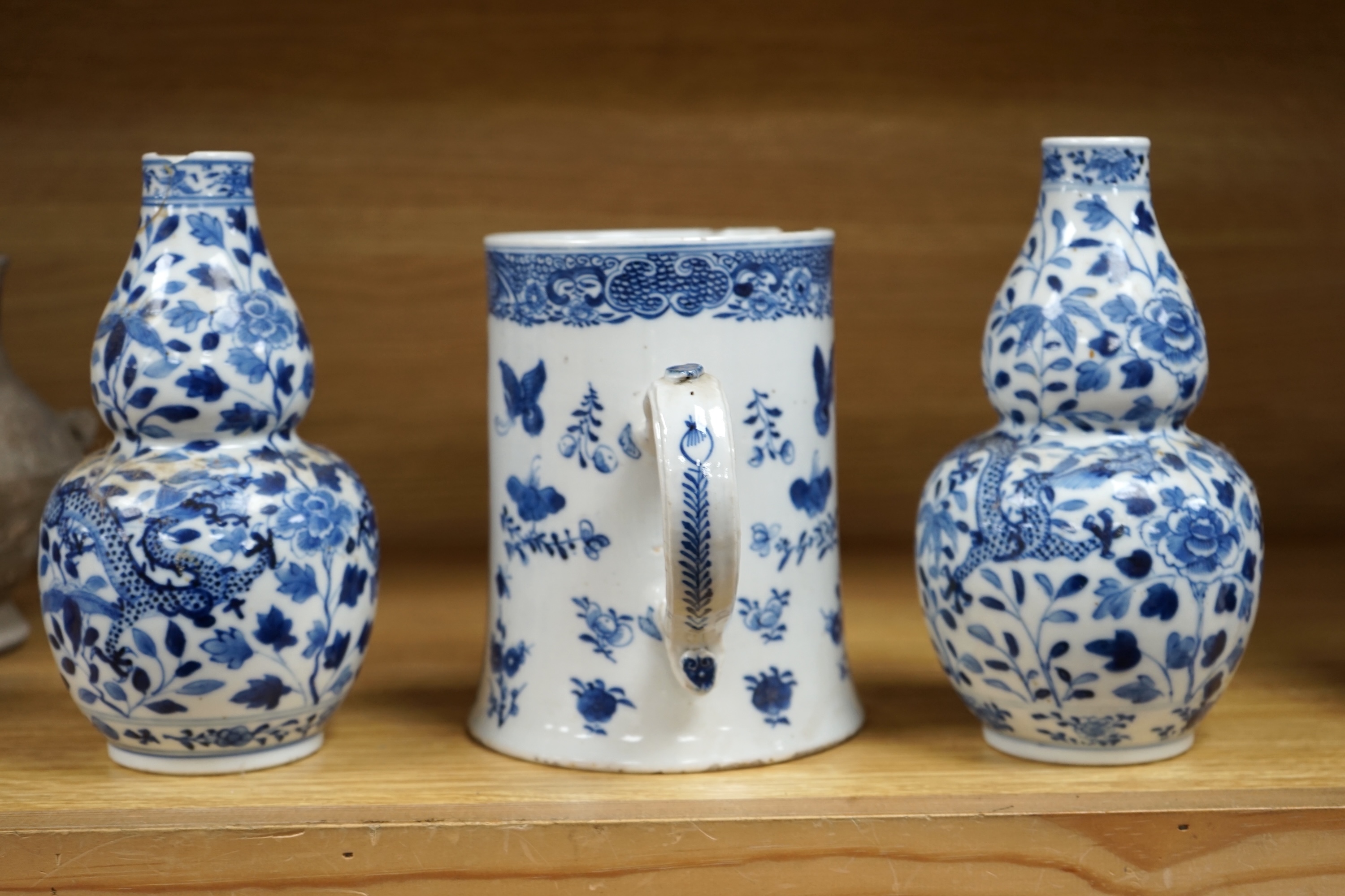 A pair of Chinese blue and white double gourd shaped vases, 19th century and a large export tankard, 18th century, largest 19cm high. Condition - poor